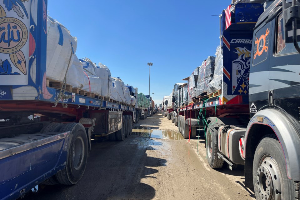 Trucks line up at the Egyptian side of the Rafah border crossing between Egypt and the Gaza Strip after Israel blocked the entry of aid trucks into Gaza, Sunday, March 2, 2025. (AP Photo/Mohamed Arafat)