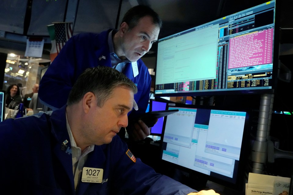 A pair of traders work on the floor of the New York Stock Exchange, Wednesday, March 12, 2025. (AP Photo/Richard Drew)