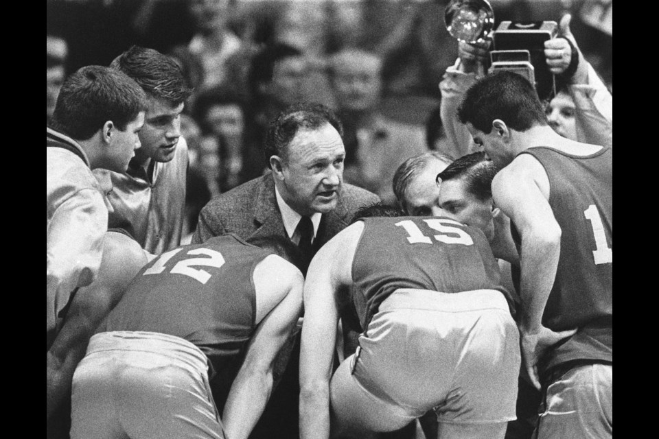 FILE - Actor Gene Hackman gives fictional Hickory High basketball players instructions during filming of the final game of the movie "Hoosiers" at Hinkle Fieldhouse on the Butler University campus, Friday, Dec. 6, 1985 in Indianapolis. (AP Photo/Tom Strickland, File)