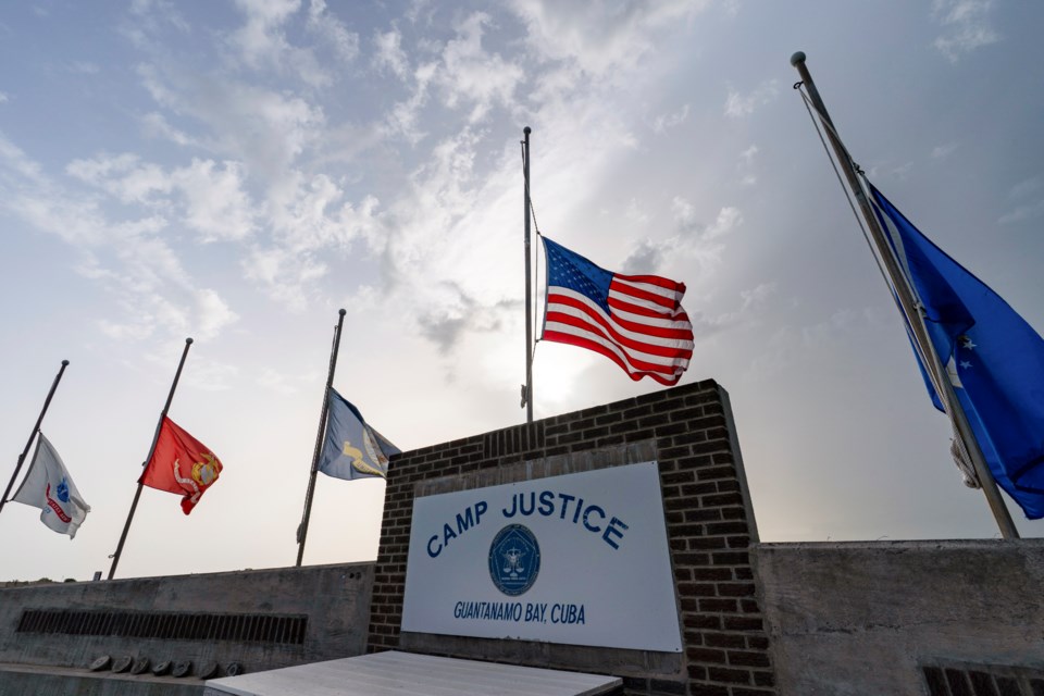 FILE - In this photo reviewed by U.S. military officials, flags fly at half-staff at Camp Justice, Aug. 29, 2021, in Guantanamo Bay Naval Base, Cuba. (AP Photo/Alex Brandon, File)