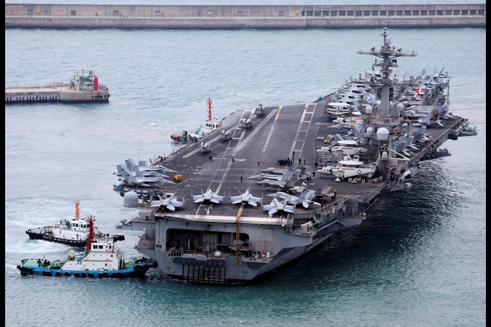 The USS Carl Vinson aircraft carrier is escorted into a navy port in Busan, South Korea, Sunday, March 2, 2025. (Son Hyung-ju/Yonhap via AP)