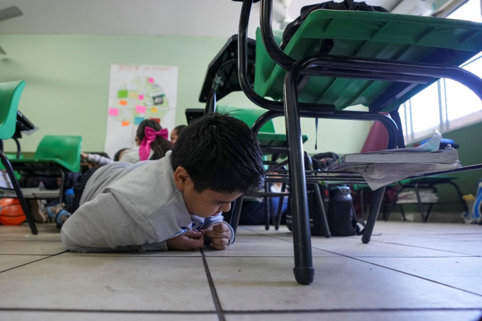 A student participates in an active shooter drill at the Socrates elementary school in Culiacan, Mexico, Thursday, Feb. 27, 2025. (AP Photo/Fernando Llano)