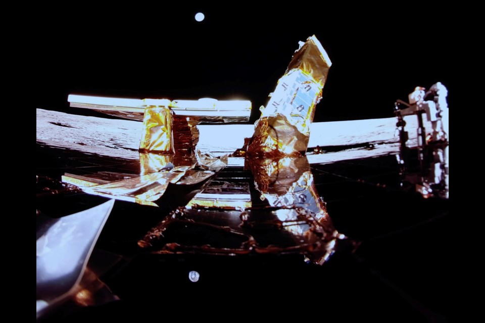 Private lunar lander Blue Ghost after touching down on the moon with a special delivery for NASA Sunday, March 2, 2025. Moon's surface and Earth are visible on the horizon, Blue Ghost's solar panel, X-band antenna, left, and LEXI payload at right. (NASA/Firefly Aerospace via AP)