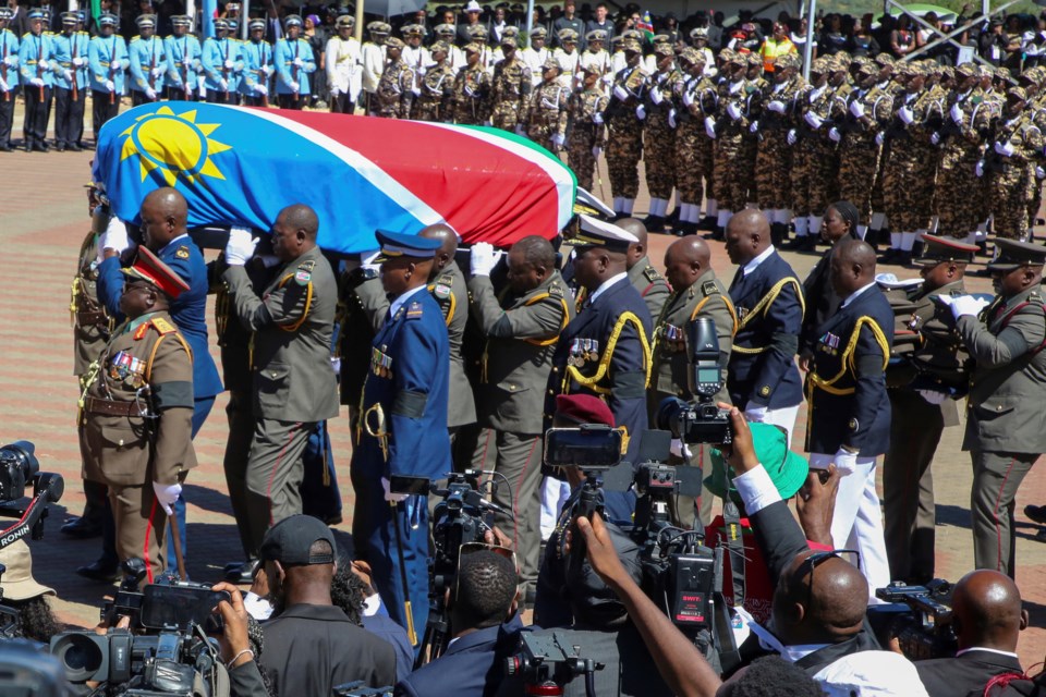 Pall-bearers carry the casket containing the remains of Namibia's founding president Sam Nujoma during his state funeral at Heroes' Acre in Windhoek, Namibia, Saturday, March 1, 2025. (AP Photo/Dirk Heinrich)