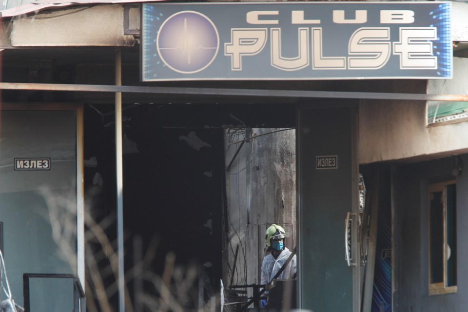 A firefighter inspects a nightclub after a massive fire in the town of Kocani, North Macedonia, Sunday, March 16, 2025. (AP Photo/Boris Grdanoski)