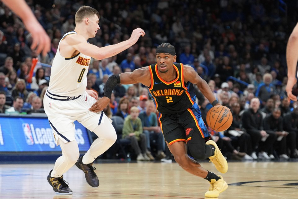 Oklahoma City Thunder guard Shai Gilgeous-Alexander (2) drives past Denver Nuggets guard Christian Braun (0) during the second half of an NBA basketball game, Sunday, March 9, 2025, in Oklahoma City. (AP Photo/Kyle Phillips)