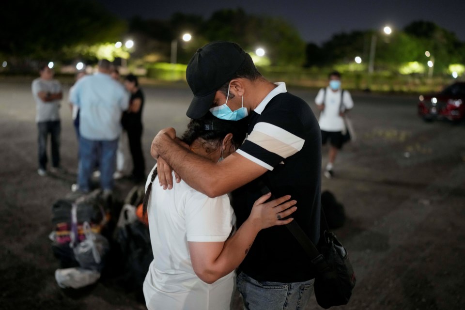 Migrants who were held in a Panamanian immigration shelter after being deported from the U.S. embraced upon arriving in Panama City on Saturday, March 8, 2025, after authorities gave them 30 days to leave the country. (AP Photo/Matias Delacroix)