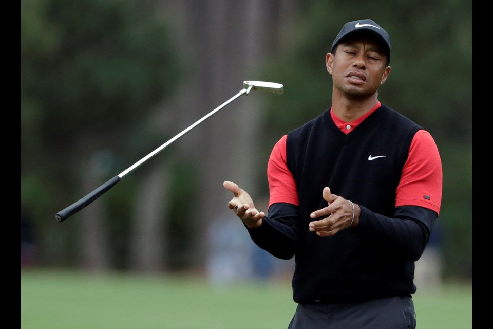 FILE - Tiger Woods flips his club after his shot to the 10th green during the final round of The Players Championship golf tournament Sunday, March 17, 2019, in Ponte Vedra Beach, Fla. (AP Photo/Lynne Sladky, File)