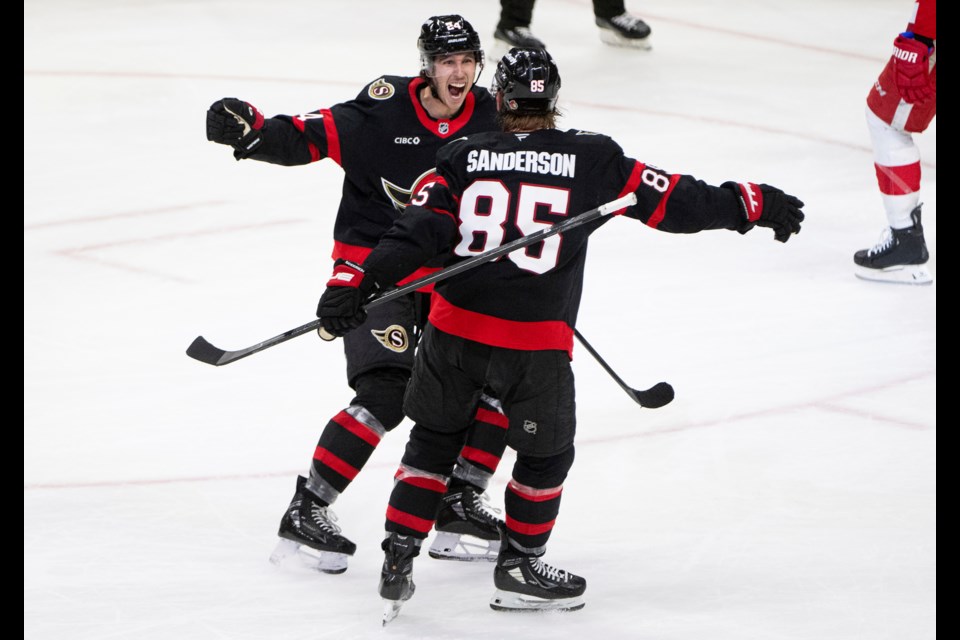 Ottawa Senators centerDylan Cozens (24) celebrates after his goal against the Detroit Red Wings with teammate Jake Sanderson (85) during third-period NHL hockey game action in Ottawa, Ontario, Monday, March 10, 2025. (Spencer Colby/The Canadian Press via AP)