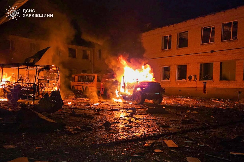 In this photo provided by the Ukrainian Emergency Service, a fire engine and school buses burn after a Russian drone hit them when firefighters were putting out the fire at a lyceum following Russian drone attack in Bohodukhiv, Kharkiv region, Ukraine, Saturday, March 15, 2025. (Ukrainian Emergency Service via AP)