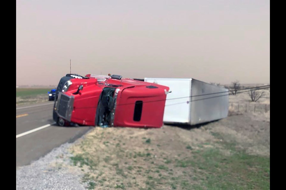 This photo provided by the Oklahoma Highway Patrol shows a tractor-trailer overturned on highway US 183 just south of Hobart, Oklahoma on Thursday, March 13, 2025. (Oklahoma Highway Patrol via AP)