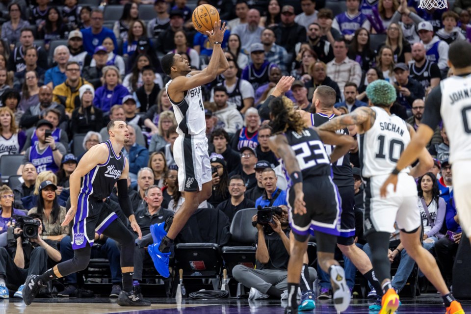 San Antonio Spurs guard De'Aaron Fox, center, goes up for a shot during the first half of an NBA basketball game against the Sacramento Kings, Friday, March 7, 2025, in Sacramento, Calif. (AP Photo/Sara Nevis)