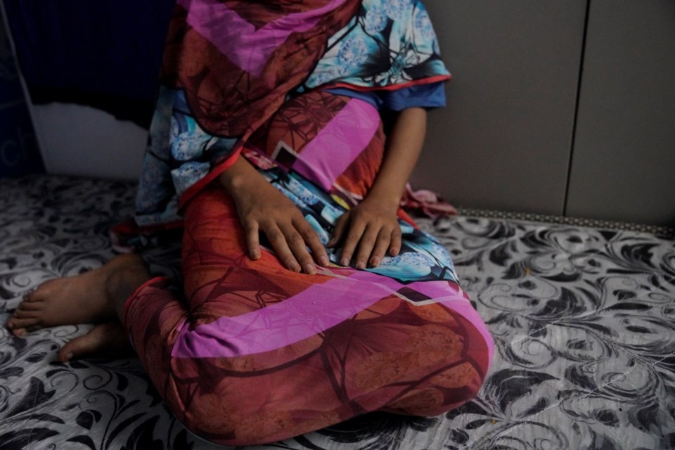 In this photograph released by UNICEF, a 16-year rape victim rests on a mattress at a UNICEF office in Sudan, Dec. 2, 2024. According to UNICEF, the girl and her 19- year- old sister, were kidnapped, beaten and raped by soldiers for four months, before they escaped and later learned they were both pregnant.(Tess Ingram/UNICEF via AP)