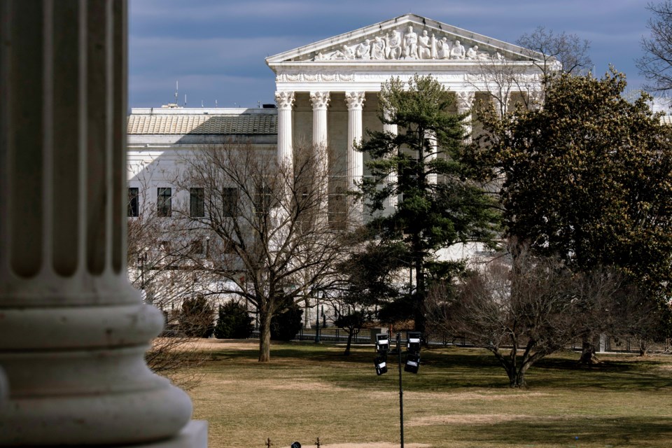 FILE - The Supreme Court is seen in the distance, framed through columns of the U.S. Senate at the Capitol in Washington, Feb. 20, 2025. (AP Photo/J. Scott Applewhite, File)