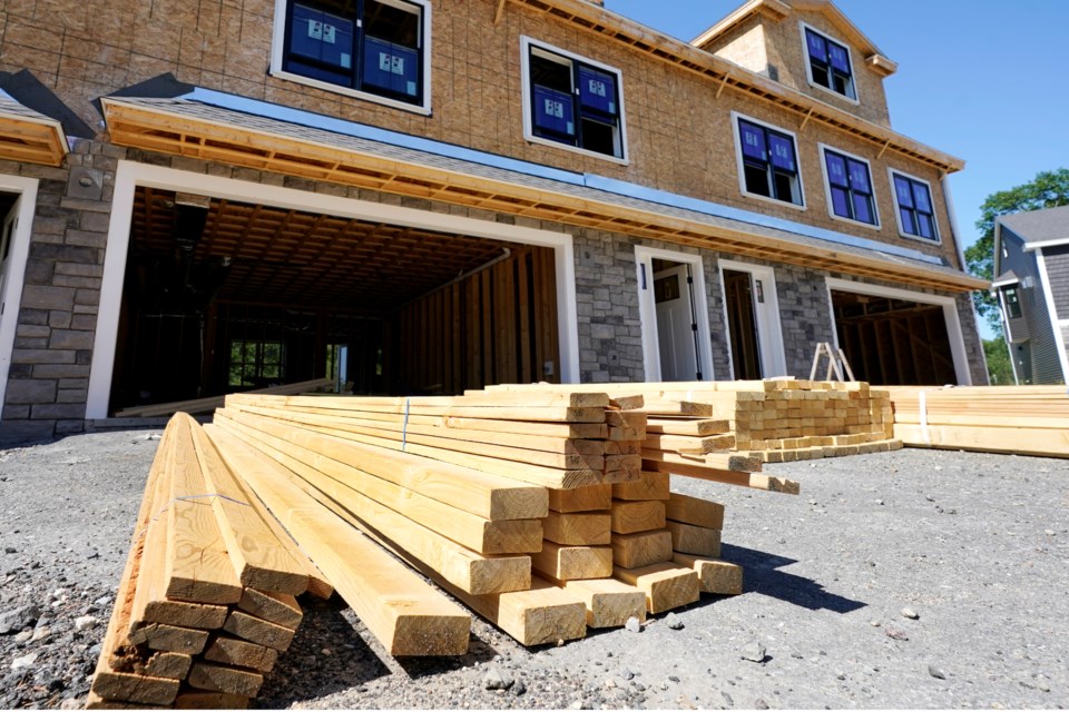 FILE - Lumber is piled at a housing construction site, Thursday, June 24, 2021, in Middleton, Mass. (AP Photo/Elise Amendola, File)