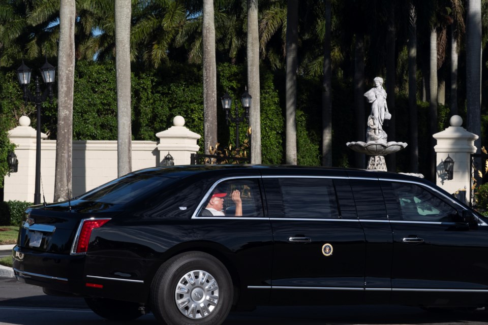 President Donald Trump waves from his limousine as he arrives at his golf club in West Palm Beach, Fla., Saturday, March 8, 2025, in West Palm Beach, Fla. (AP Photo/Manuel Balce Ceneta)