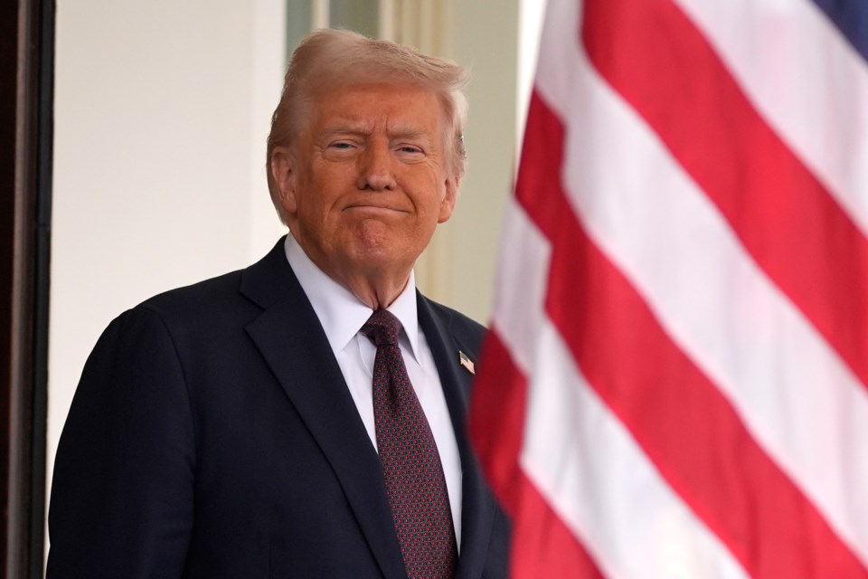 President Donald Trump stands before British Prime Minister Keir Starmer arrives at the White House, Thursday, Feb. 27, 2025, in Washington. (AP Photo/Evan Vucci)