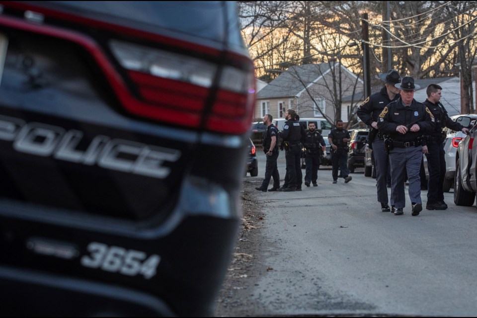 Charlottesville police congregate along Stribling Avenue on the border of the city's Fifeville and Jefferson Park Avenue neighborhoods, Thursday, Feb. 27, 2025, after taking a man into custody suspected of a knife attack on University of Virginia Grounds. (Cal Cary/The Daily Progress via AP)