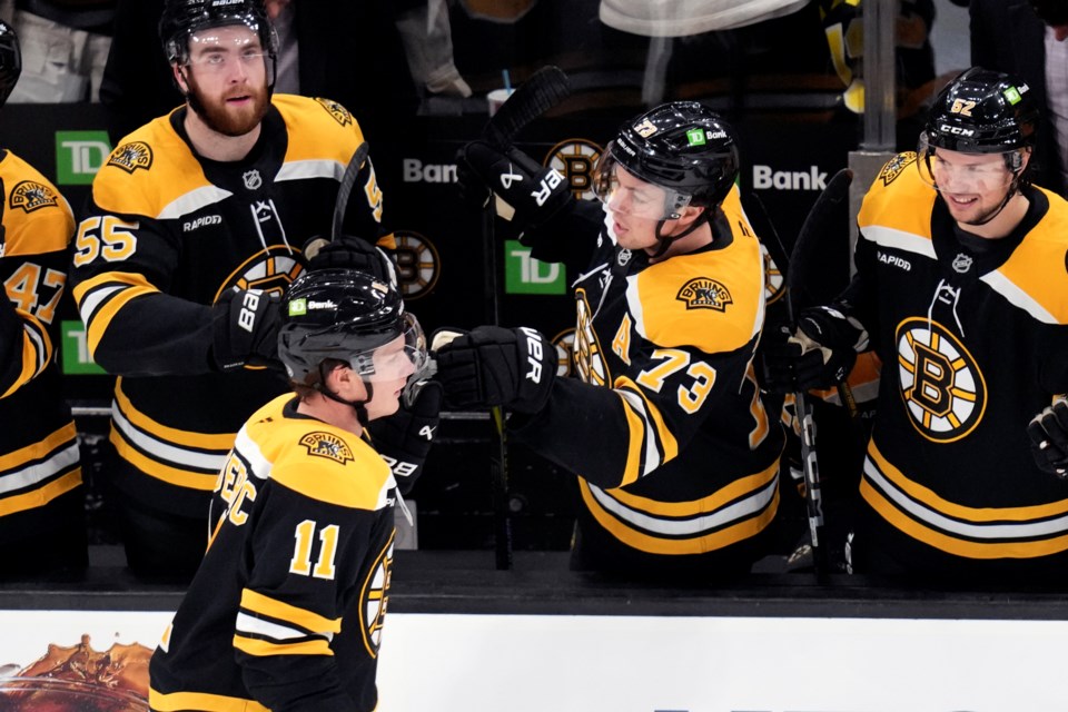 Boston Bruins center Trent Frederic (11) is congratulated after his goal against the Minnesota Wild during the second period of an NHL hockey game, Tuesday, Feb. 4, 2025, in Boston. (AP Photo/Charles Krupa)