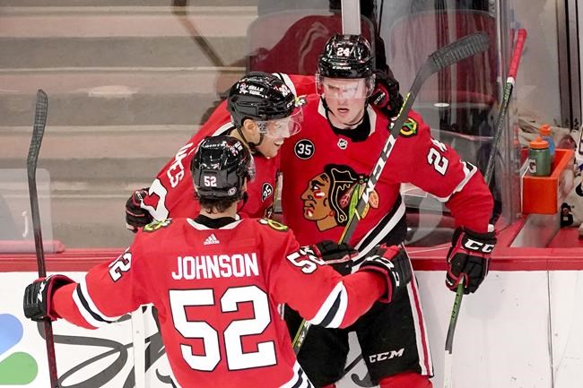 Chicago Blackhawks center Kirby Dach, right, celebrates his tying