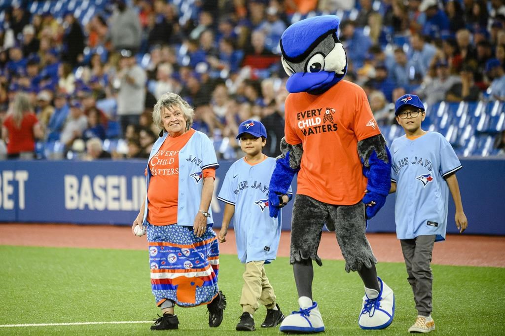 Residential school survivor throws first pitch at Jays game for