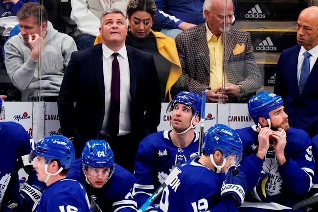 Sheldon Keefe appears to give Matthew Knies some bad news on