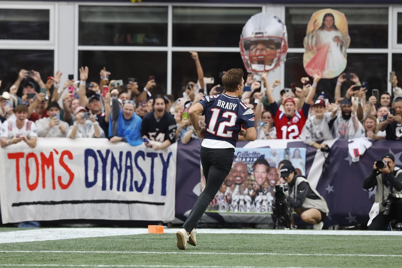 A New England Patriots fan wears a hat shaped like a Super Bowl