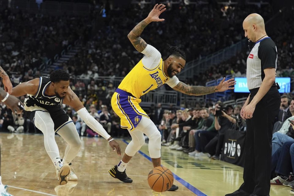 Reaves' tripledouble, tiebreaking 3 helps rally Lakers past Bucks in