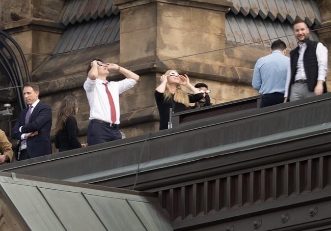 MPs clad in eclipse glasses stare at 'surreal' celestial event on ...