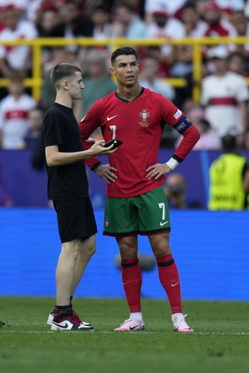 Two fans get on field for selfies with Cristiano Ronaldo during match at  Euro 2024 - Vancouver Is Awesome