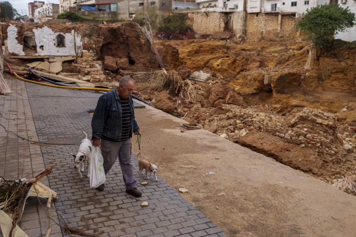 Mud-caked Volunteers Clean Flood Debris In A Spanish Town As ...