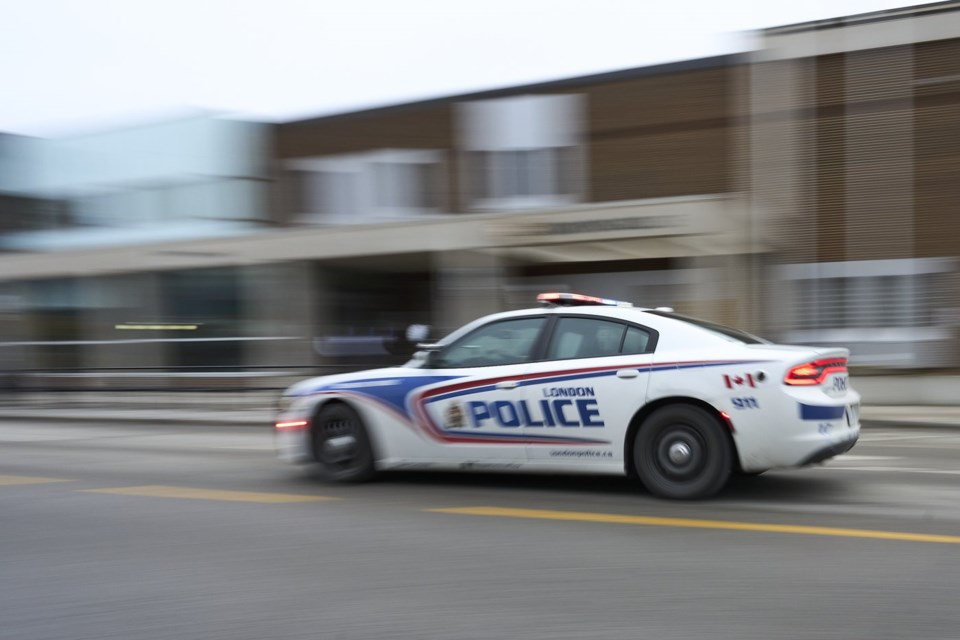 A police car drives by London Police headquarters in London, Ont., Monday, Jan. 29, 2024.