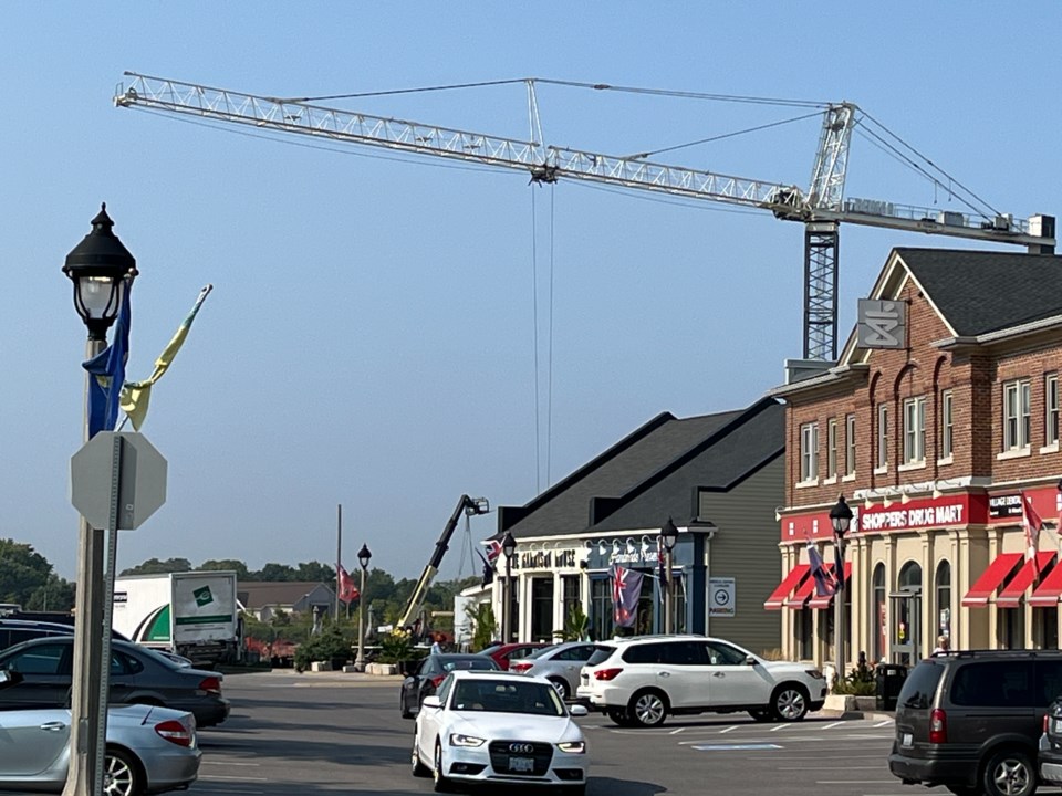 USED good-morning-mb-a-crane-towers-over-over-the-shops-at-the-village-as-construction-begins-for-the-next-phase