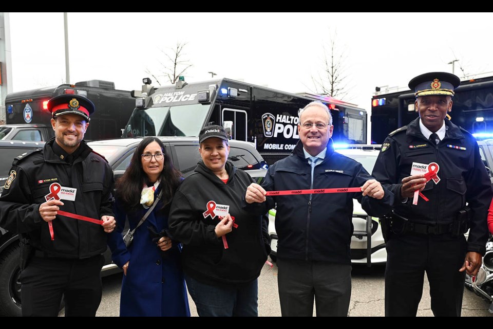 Ontario Solicitor General Michael Kerzner, second from right, joins Halton Police deputy chief Roger Wilkie and OPP deputy commissioner Rohan Thompson along with MADD Canada officials to kick off the Red Ribbon campaign at the annual Festive R.I.D.E. campaign against alcohol and drug impaired driving.