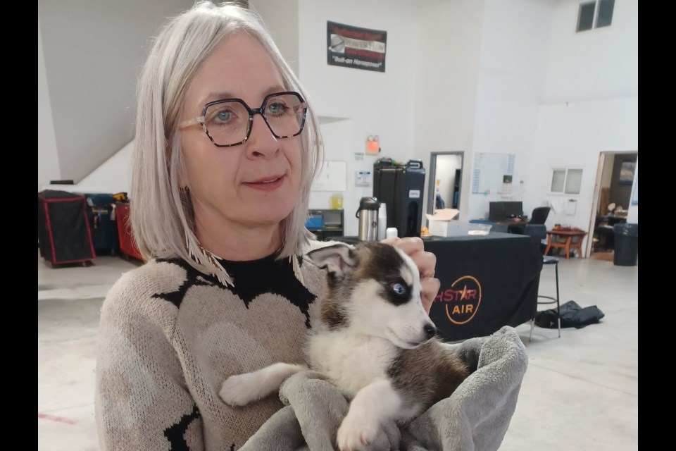 Patty Hajdu, Indigenous services minister and MP for Thunder Bay-Superior North, holds a pup from Sandy Lake before a news conference in Thunder Bay on Oct. 11, 2024.