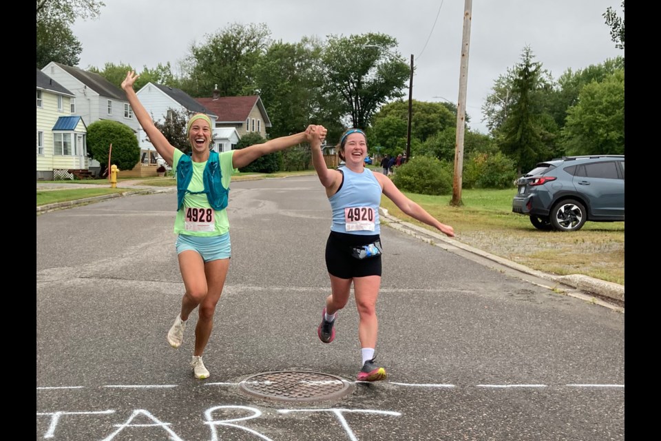 Elina Ranta-Diegel and Arleigh Shields cross the finish line together at the 2024 Paju Mountain Run on Aug. 10.