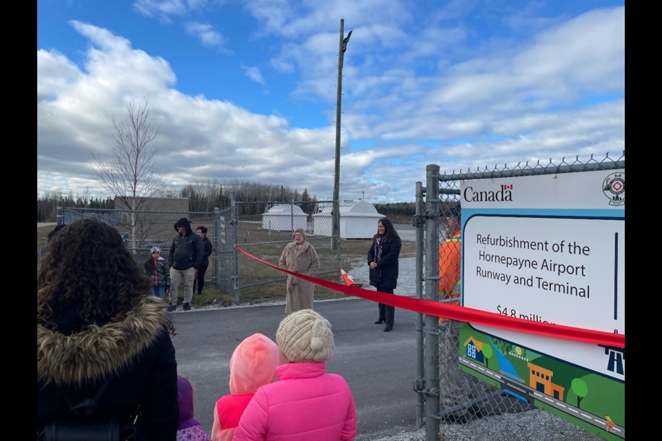 Mayor Cheryl Fort and community members gather to celebrate ribbon cutting ceremony to mark completion of airport runway rehabilitation project.
(Photos submitted by Township of Hornepayne)