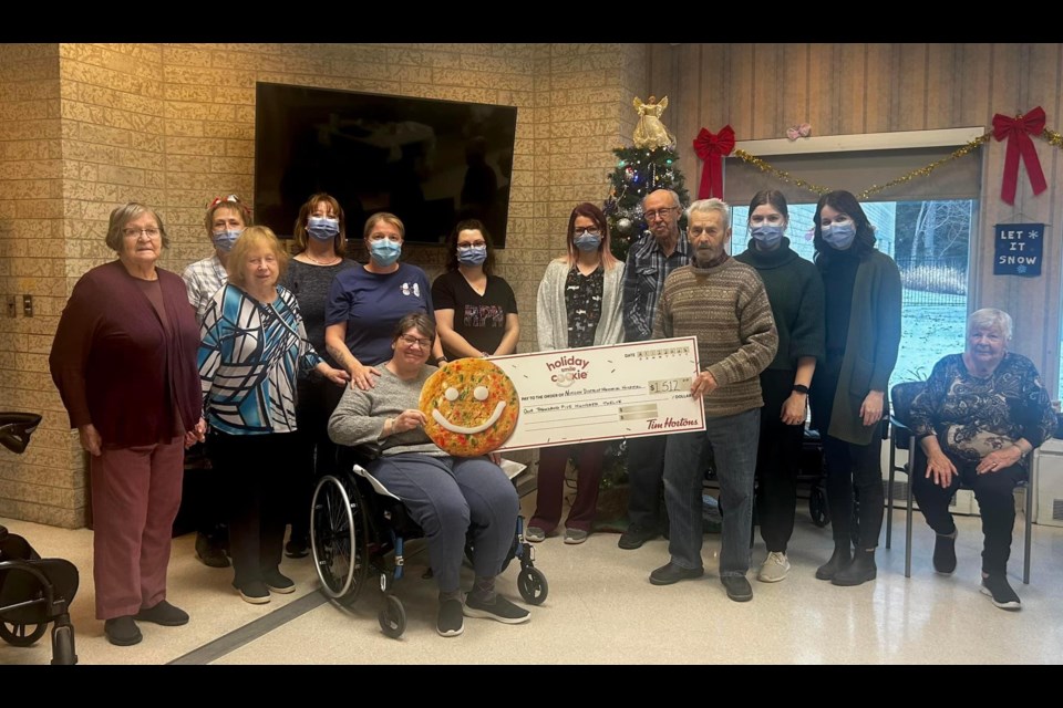 Residents and staff at Nipigon District Memorial Hospital's long-term care ward pose for a picture with their big cheque on December 21, 2023.