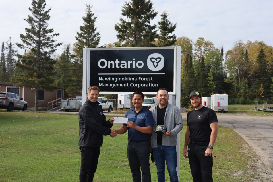 From left, NFMC’s public relations and marketing coordinator Brett Redden presents $10,000.00 cheque to hole-in-one winner Jim Principe, alongside playing partner Vinnie Nabigon, and tournament committee rules official Kurtis Atkinson