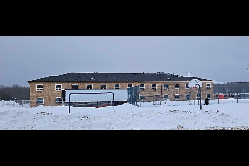 Roofers shingle the roof of the new hotel in Hornepayne (TedandDeb Scheniman/Facebook)