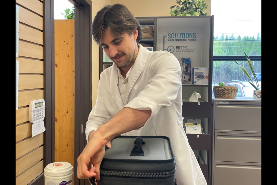 Drone technician, Cameron Rowe, loads insulin into the container which will make its way 30 kilometres northwest to Trout Lake. Pictured here on May 22, 2024.