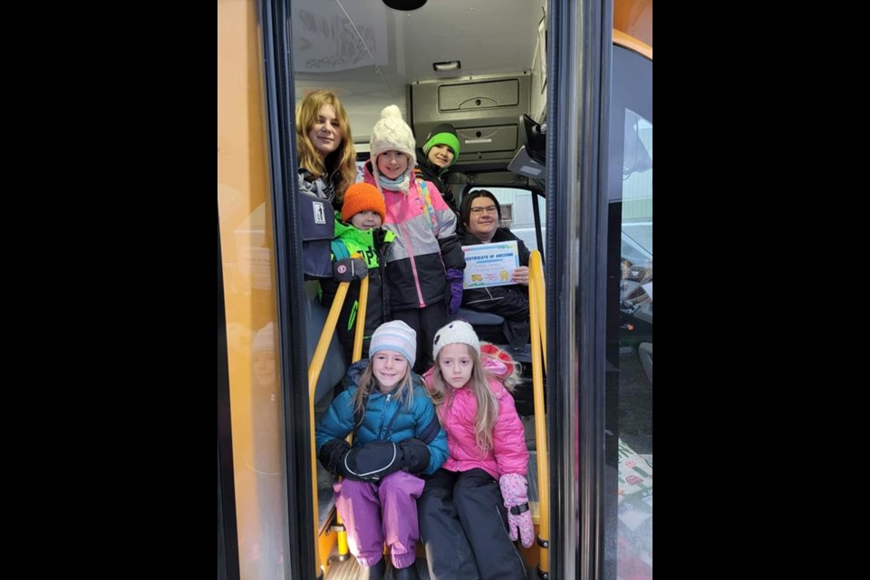 Michelle Ferraro with her certificate of appreciation and a group of the students who travel with her on her bus.
www.facebook.com/nakinapublicschool
