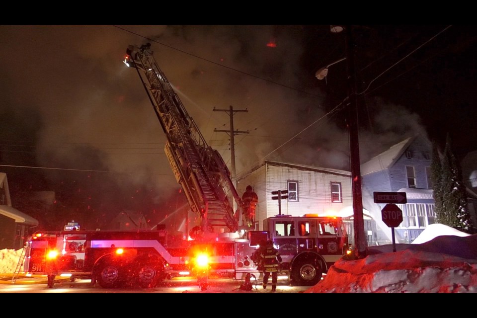 Firefighters battle fires at two structures side-by-side at the corner of Helen Street and Leroy Street in Sault Ste. Marie.