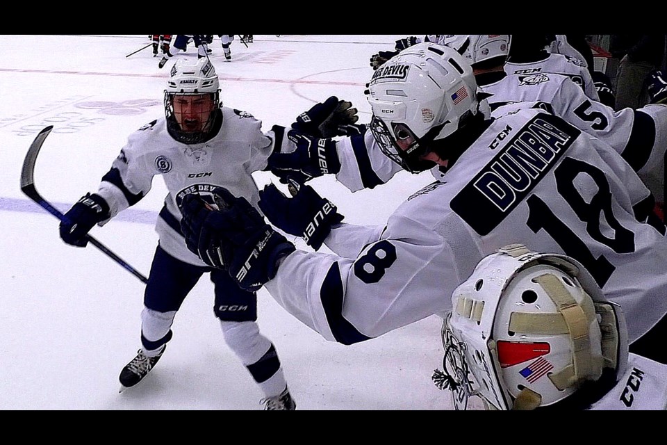 Rander Blair is congratulated by the Blue Devil bench after scoring the 1st goal of the game against TC Bay Reps Friday evening.