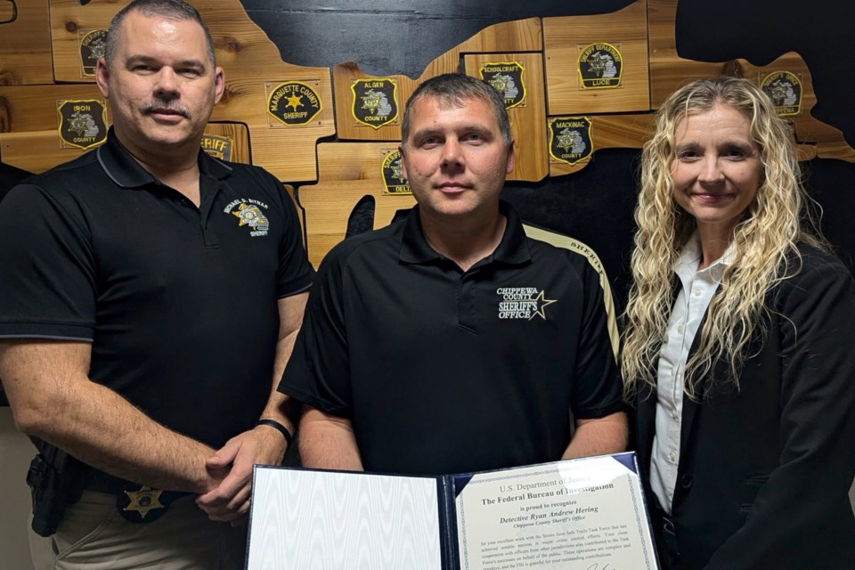 Undersheriff Ryan Hering (middle) received the FBI Directors award for his outstanding work as team leader with his time on TRIDENT.