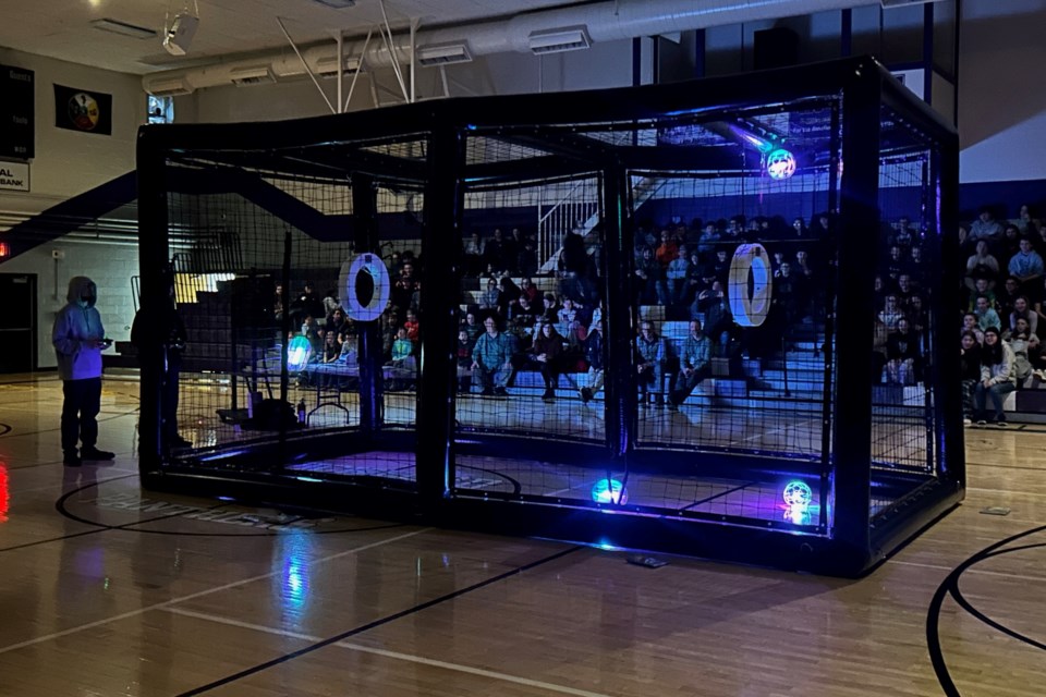 Students cheered when the lights were dimmed for a round of Drone Soccer competition.