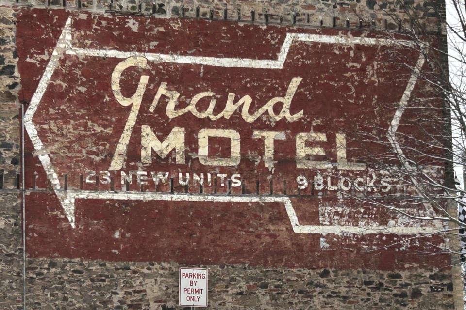 The advertisement for the Grand Motel is weathered, but still legible on the side of this downtown Sault Ste. Marie building.