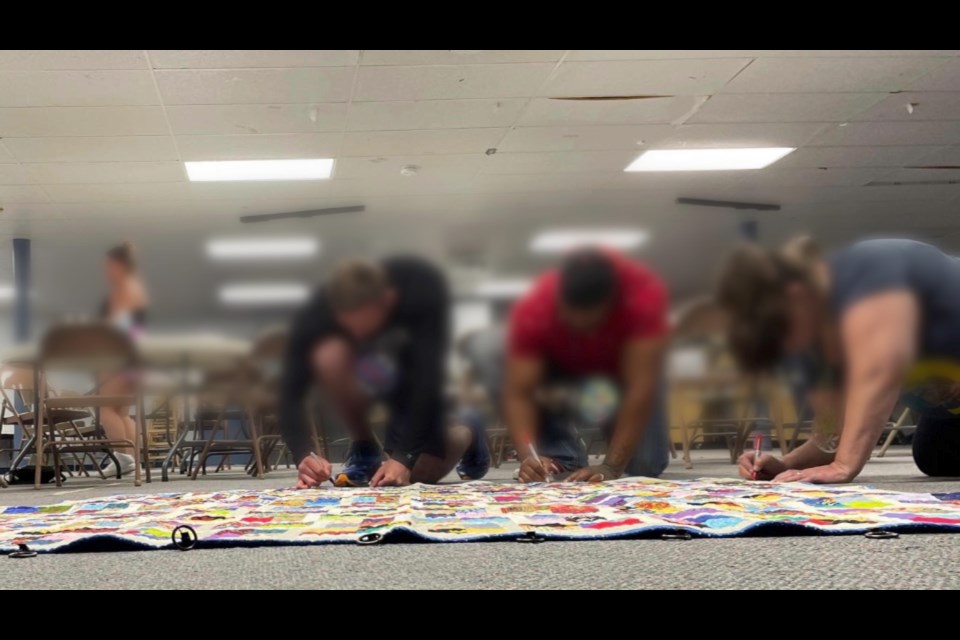 People at a previous Hope Heroes workshop signed a recovery quilt.