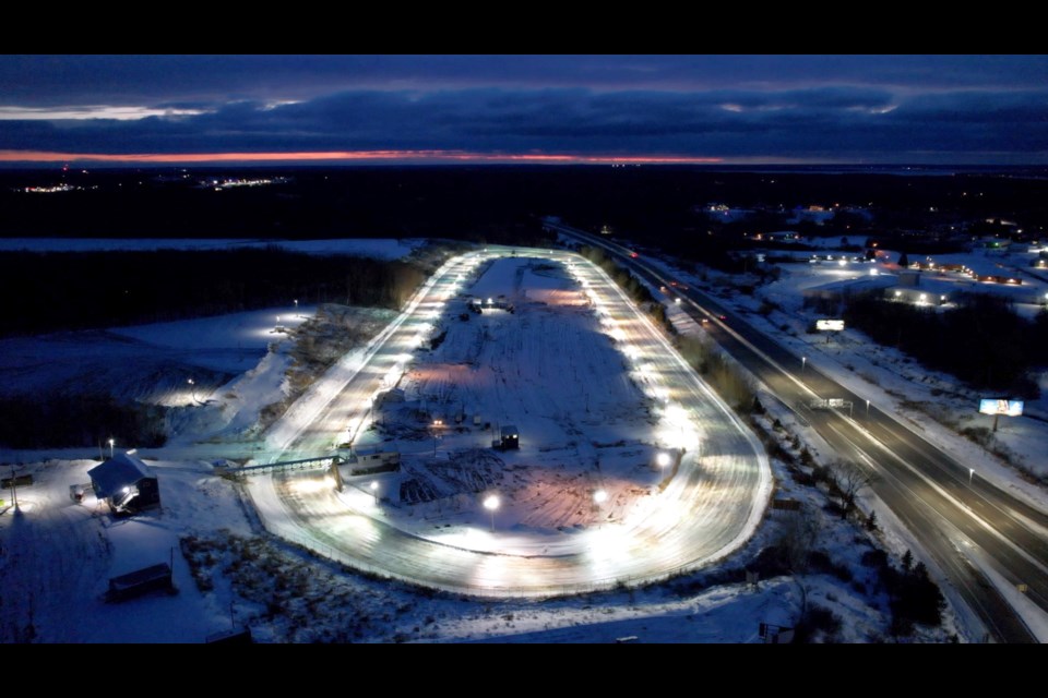 Volunteers at the I-500 track in Sault Ste. Marie are laying water down on the track to build up ice.