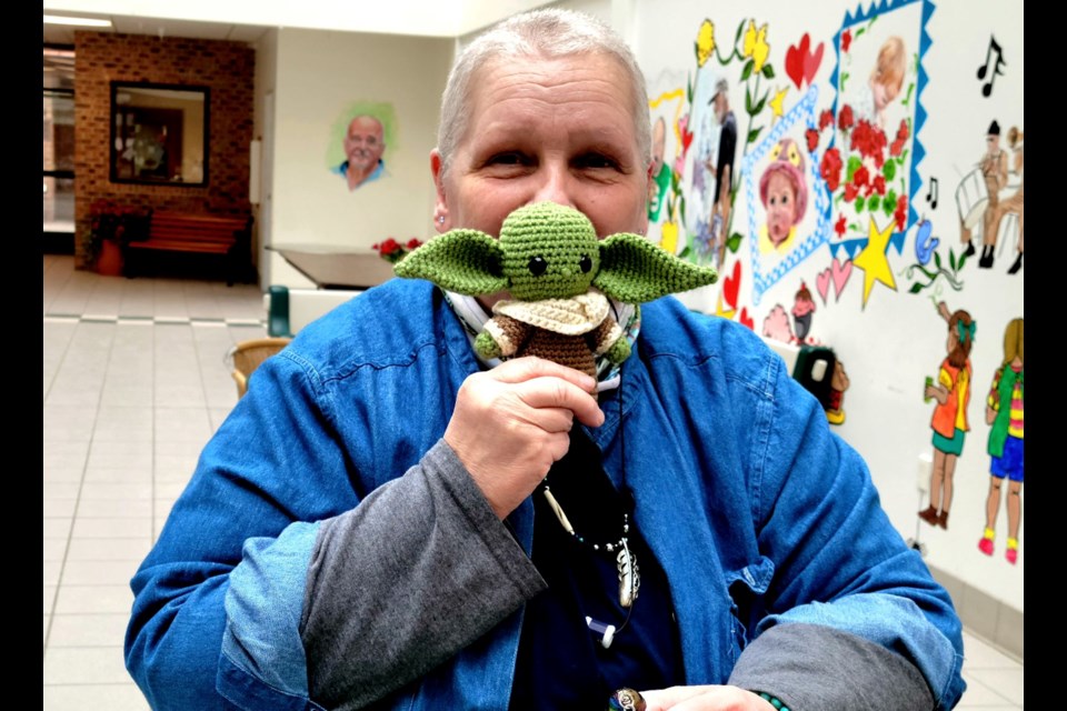 Colleen Smith of Avery Square selling crotche dolls at Avery Square craft show on Friday, April 8.